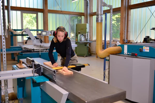 Eine Studentin arbeitet in der Tischlerei Eine Studentin arbeitet in der Tischlerei